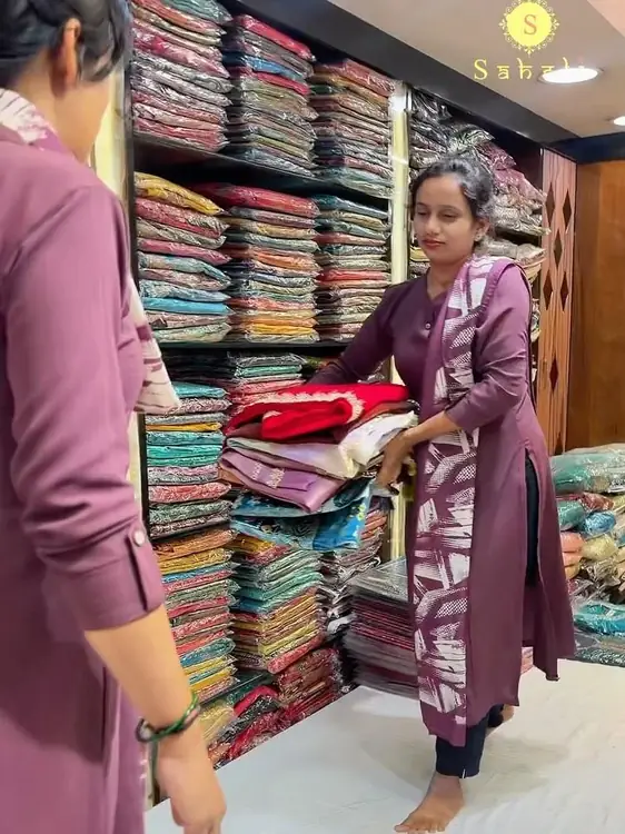Shelves stacked with sarees